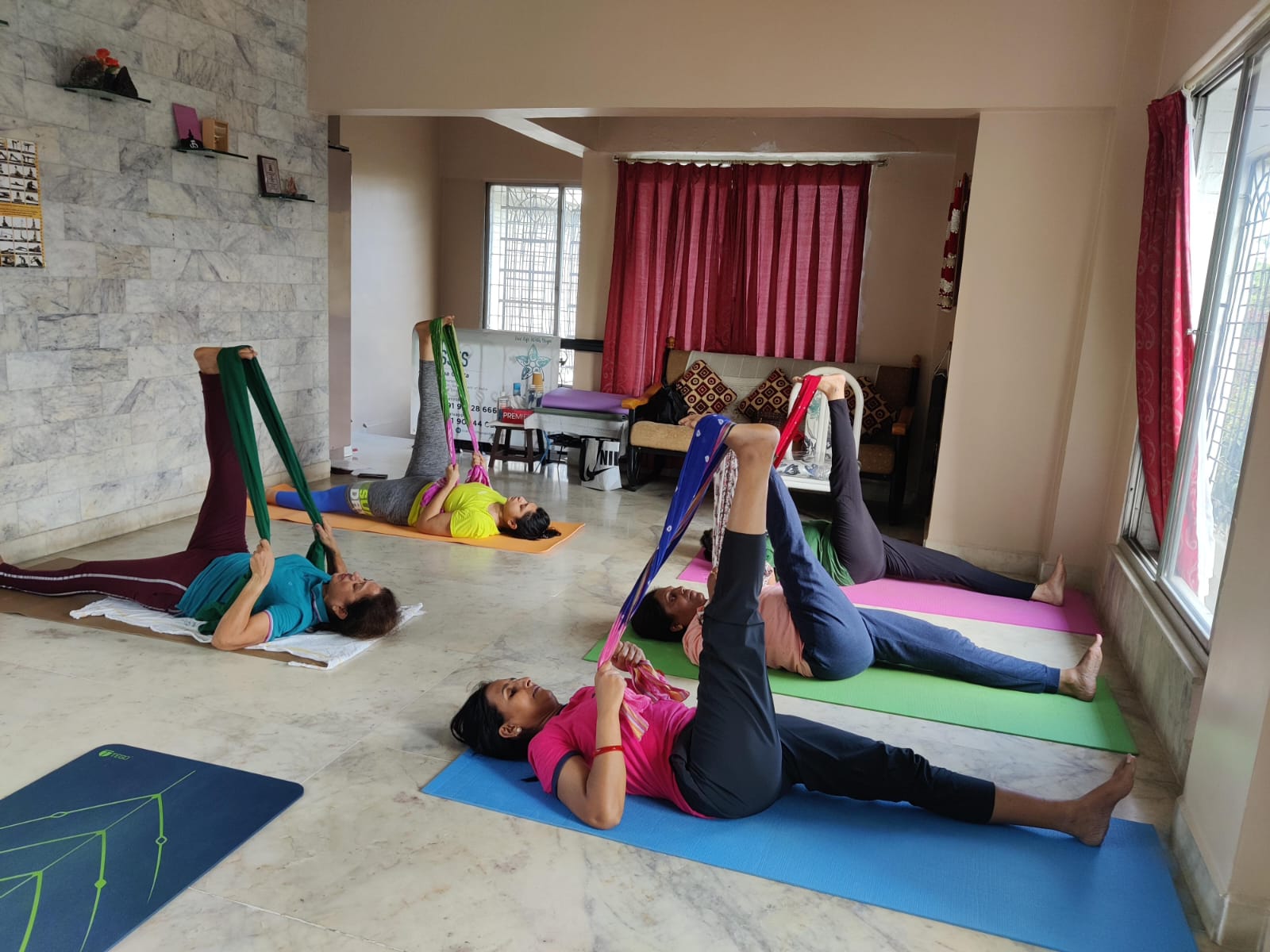 Group yoga class using stretching bands